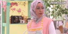 a woman wearing a hijab and apron is on a tv show called real time