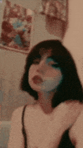 a girl with short hair and a mask on her face is taking a selfie in front of a mirror .