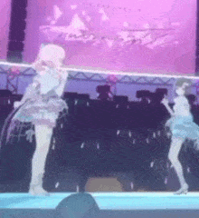 two anime girls are dancing on a stage with a microphone .