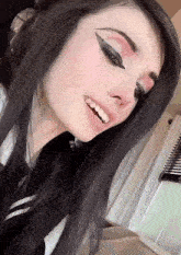 a close up of a woman 's face with black hair
