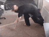 a person is standing on a carpeted floor in a room with a chair .