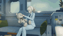 a woman in a suit is sitting on a couch holding a teddy bear and a clock reads 28