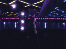 a girl in a black dress is standing in front of a stage