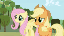 a couple of ponies are standing next to each other in a field