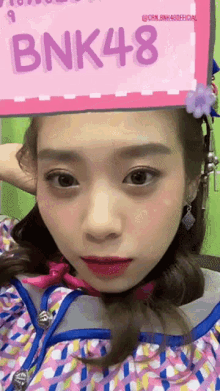 a girl with bnk48 on her head