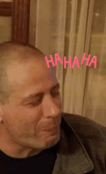 a man is laughing with the word hahaha on his head