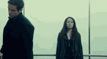 a man and woman are standing next to each other