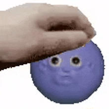 a hand is holding a blue balloon with a face on it .