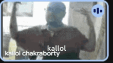 a man is standing in front of a window with his arms outstretched and the words kallol chakraborty on the bottom .