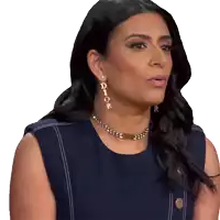 a woman wearing a dior necklace and earrings looks to the side