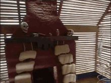a fireplace with skulls on the mantle and a bottle on it