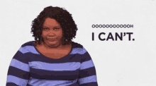 a woman in a striped shirt is making a funny face and saying `` i can 't . ''