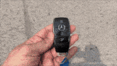 a person is holding a car key that has a sticker on it that says ' youtube.com/namastecar ' on it