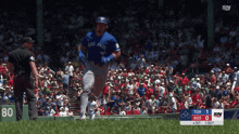 a baseball player for the blue jays is running on the field during a game
