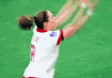 a female soccer player wearing a white jersey with the number 3 on it