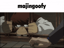 a picture of a man behind bars with the words majingoofy above him