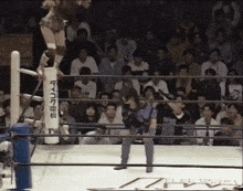 a woman in a wrestling ring with a sign that says ' nv ' on it