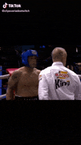 two men are boxing in a ring and one of them is wearing gloves