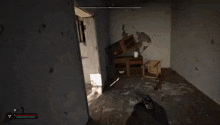 a person is holding a gun in a video game and looking out of a doorway .