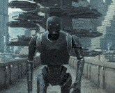 a robot is walking down a walkway in front of a building that says ' star wars ' on it