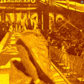 a crowd of people gathered in front of a sign that says american