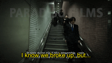 a group of people walking up stairs with the words i know we broke up but in yellow