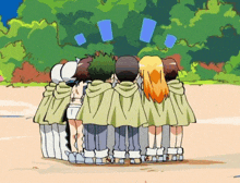 a group of children are standing in a circle looking at something .