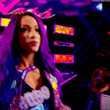 a woman with purple hair is wearing a blue jacket that says boss on it .