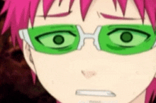 a close up of a person wearing green glasses and making a face .