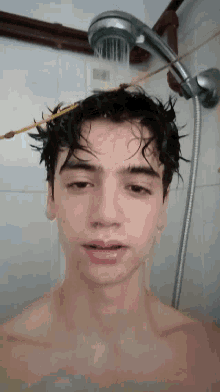 a man is taking a shower with a shower head hanging from his head