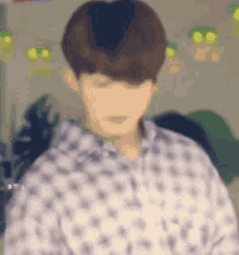 a blurry picture of a man wearing a white shirt with a pattern .