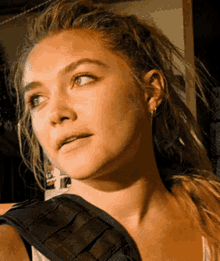 a close up of a woman 's face looking to the side