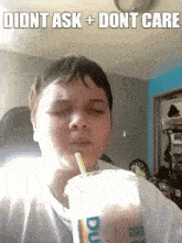 a young boy drinking a dunkin donuts drink with a straw ..