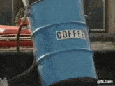 a blue barrel with the word coffee on it .