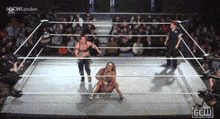 two women are wrestling in a ring with a crowd watching and the word london on the bottom right