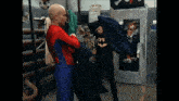 a man in a spiderman costume is standing next to another man