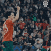 a soccer player with the number 13 on his jersey is giving the middle finger
