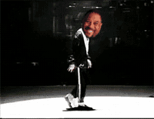 a man is dancing on a white surface with a black background