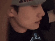 a close up of a man 's face wearing a hat .