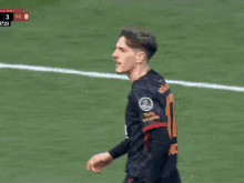 a soccer player wearing a sixt shirt stands on a field