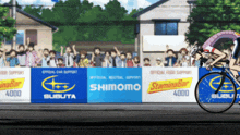 a person riding a bike in front of a banner that says shimomo
