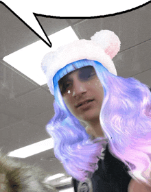 a man wearing a wig and a hat with a speech bubble above his head