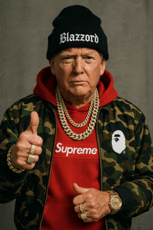 a man wearing a supreme sweatshirt and a black beanie