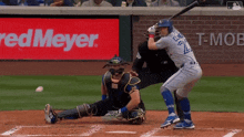 a baseball player with the number 2 on his jersey swings at a ball