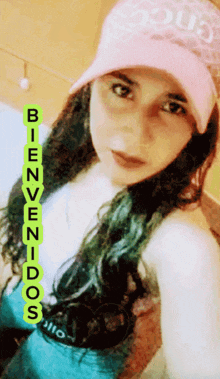 a woman wearing a pink hat says bienvenidos on the bottom