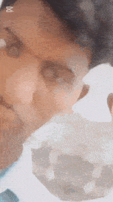 a close up of a person 's face with the letter x on the bottom right