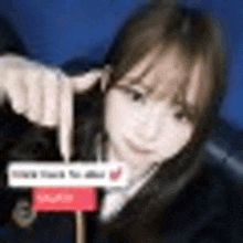 a close up of a woman 's face with a sign in the background .