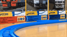 a display of toy trains with a blue track going through it