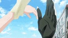 a person holding another person 's hand in front of a building