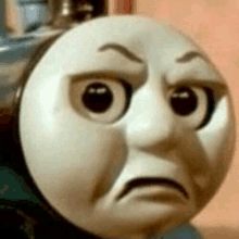 thomas the tank engine is making a sad face .